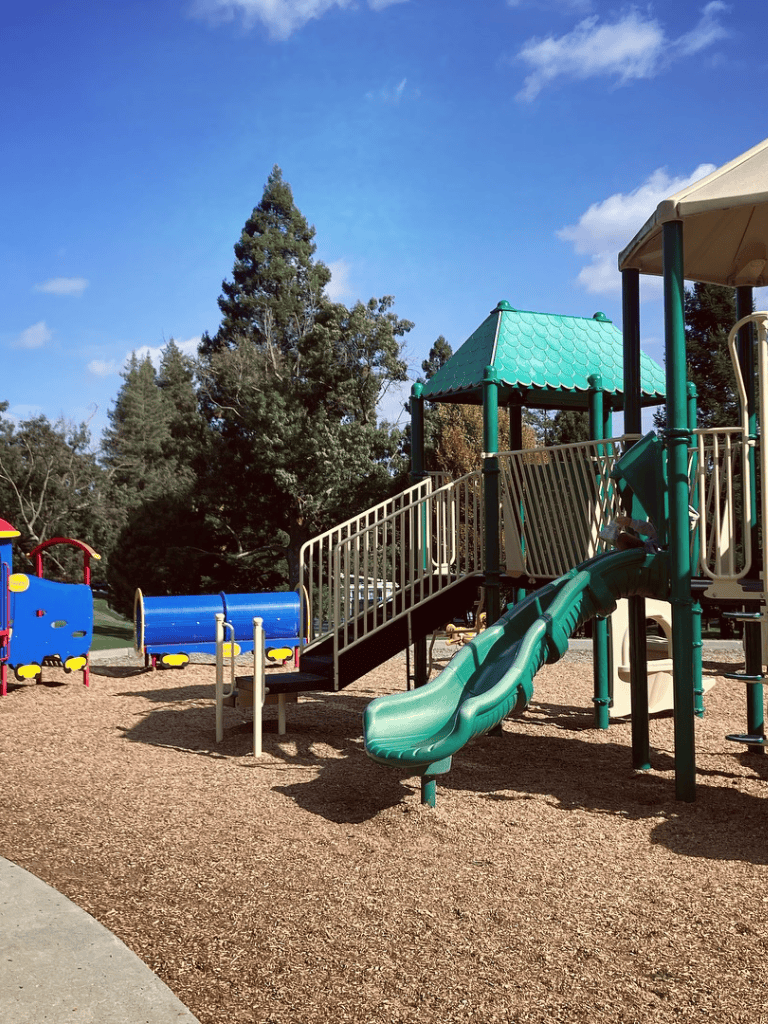 Colorful children's playground equipment at QuestForDirections park, perfect for family fun and outdoor activities.