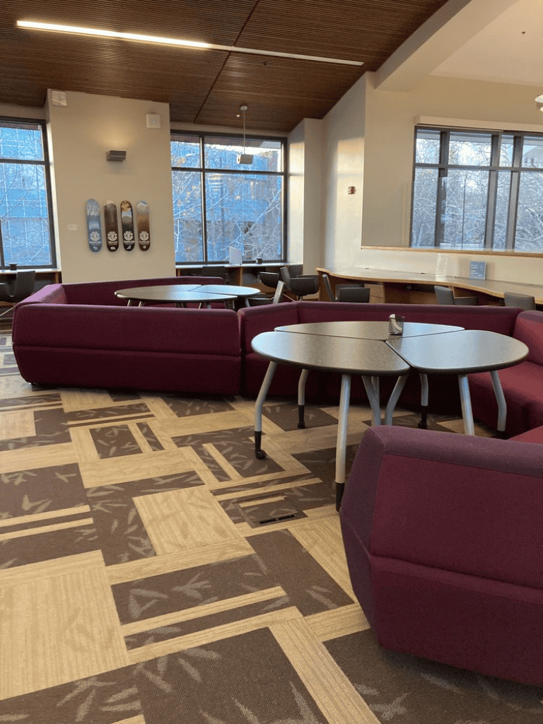 Relaxed lounge area with cozy seating and large windows at QuestForDirections.