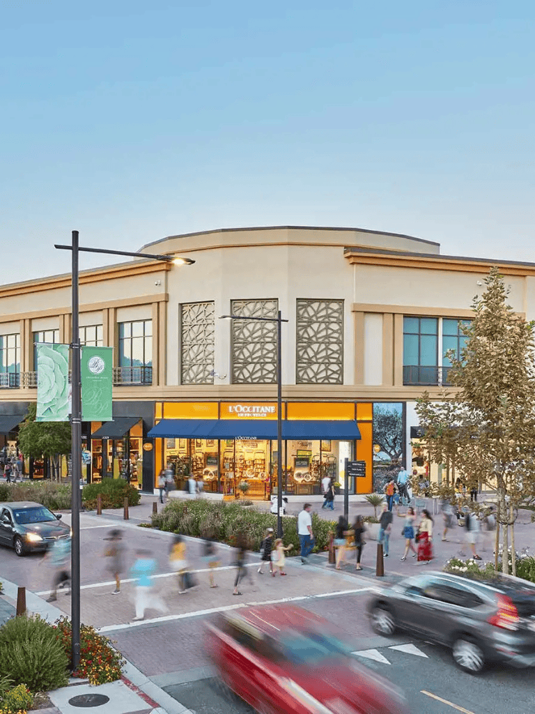 Vibrant shopping district with L’Occitane store and pedestrian crosswalk outside QuestForDirections.