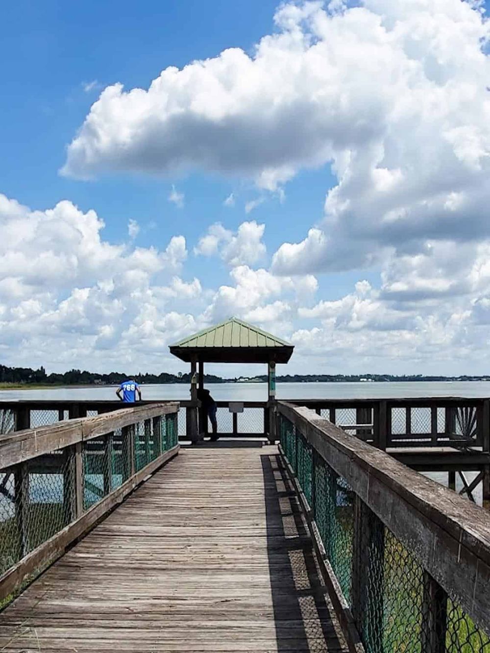 Scenic waterfront pier with gazebo, perfect for fishing and relaxing by the water.