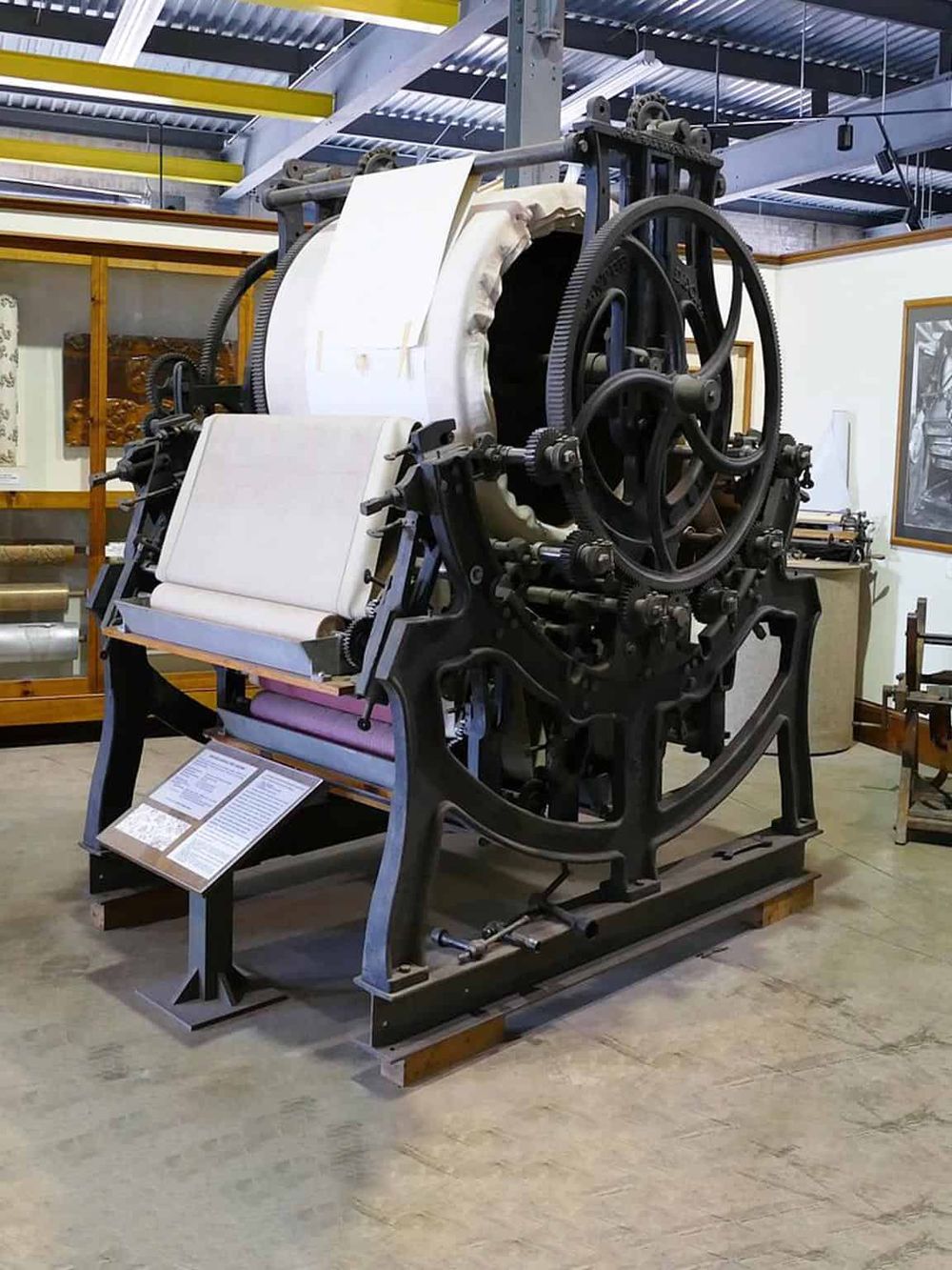 Old printing press machinery at a museum exhibit.