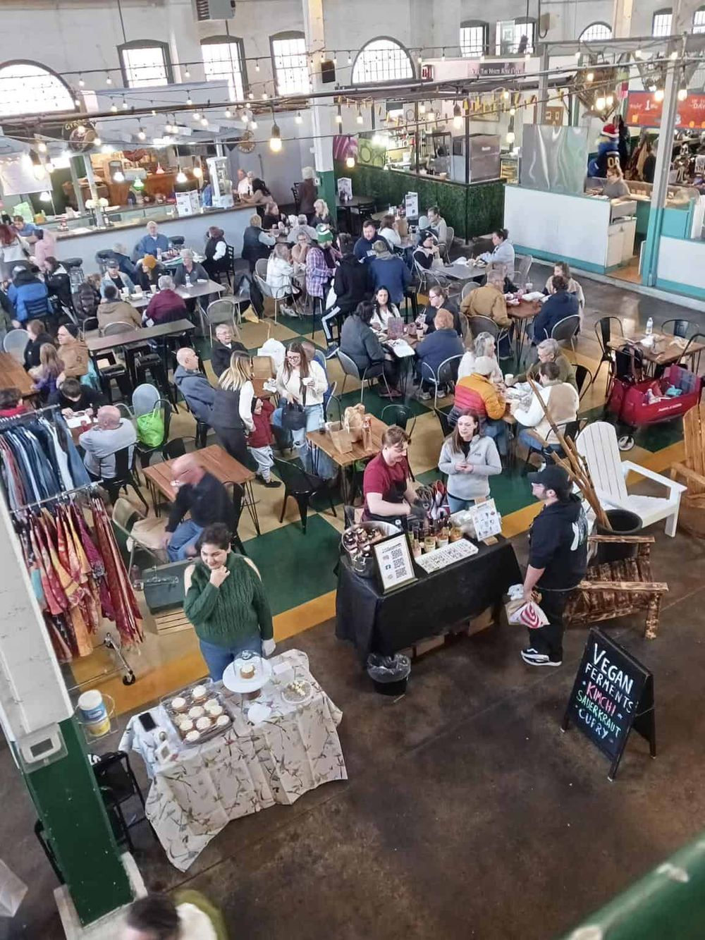Busy urban indoor food market with diverse shoppers and vendors at QuestForDirections.