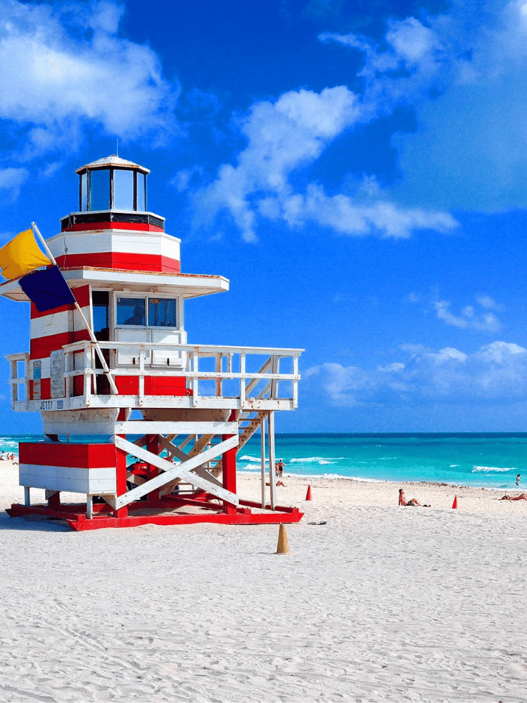 Lifeguard tower on Miami Beach with clear blue sky and ocean in background.