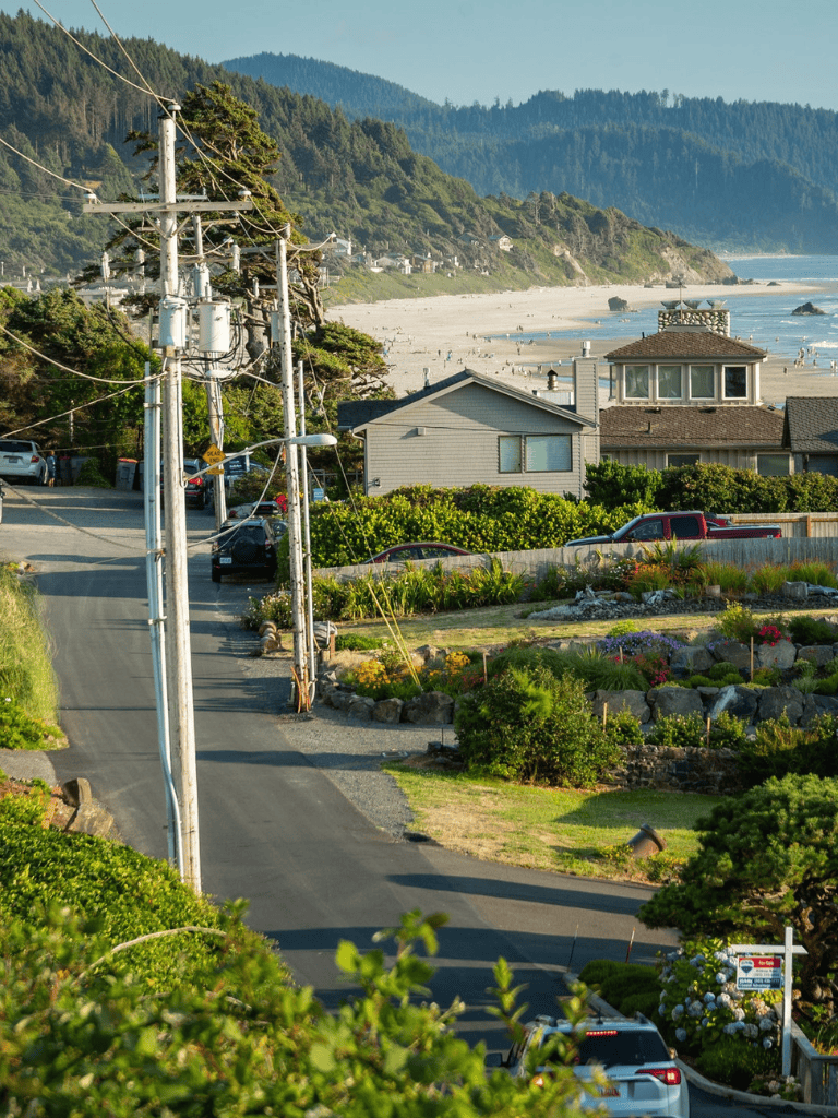 Cliffside neighborhood near the beach with houses, greenery, and coastal views.