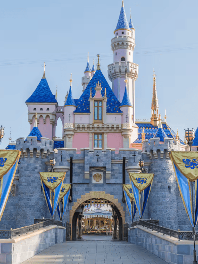 Colorful Disney castle at Disneyland with blue spires and fairy tale design.