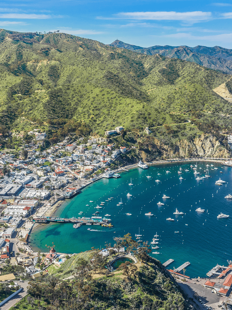 Beverly Hills coastal town with scenic mountains and marina, perfect for travel planning.