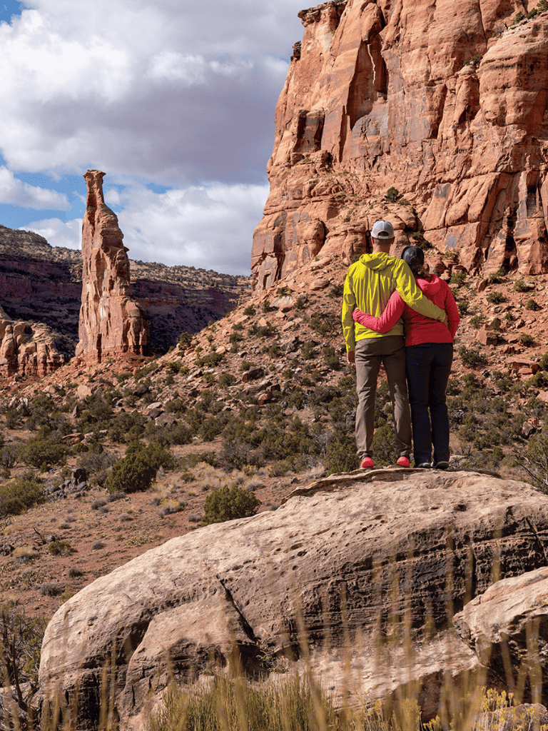 A couple enjoying a scenic hike in Zion National Park amidst red rock formations.