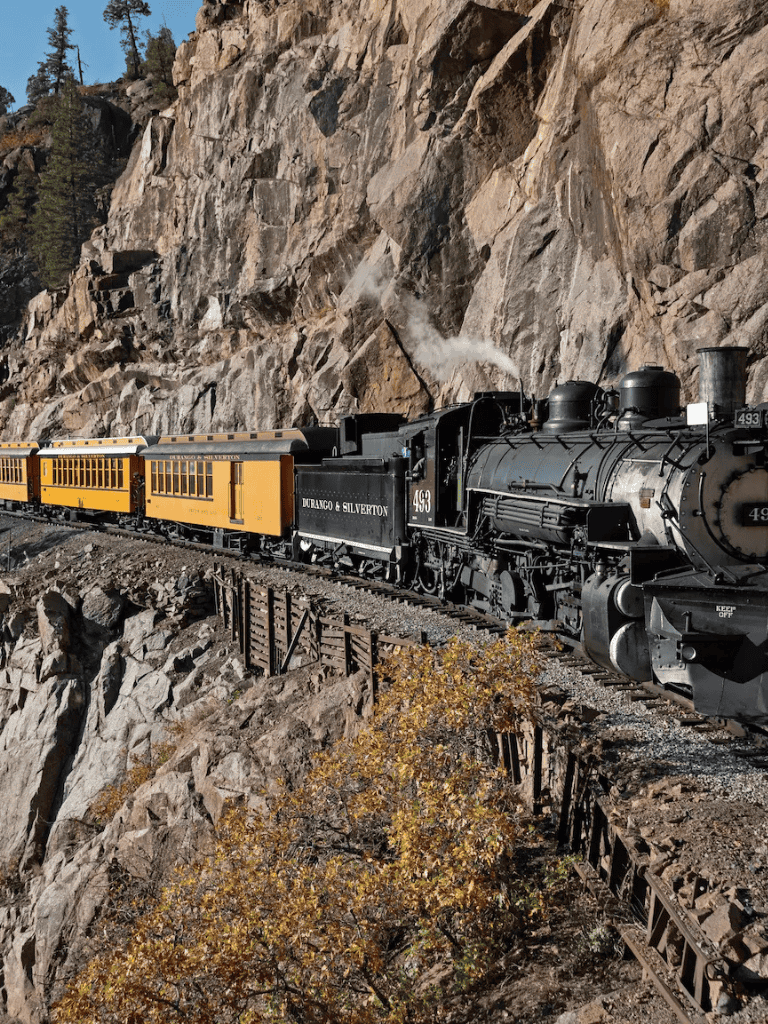 Durango & Silverton Narrow Gauge Train through rugged mountain landscape.