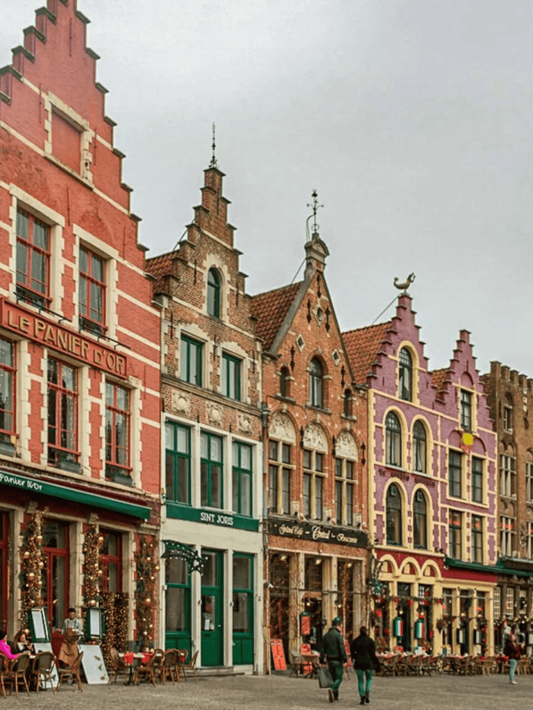 Colorful historic European city street with decorative buildings and outdoor cafes, vibrant and lively atmosphere.