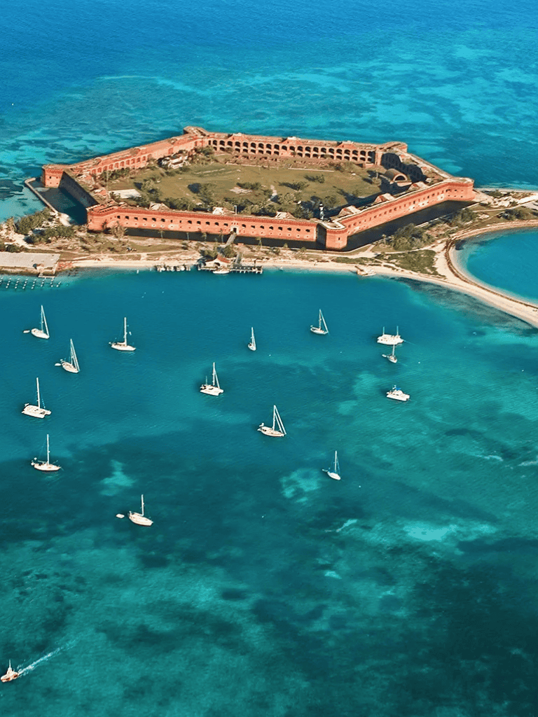 Aerial view of Fort San Juan de Ulúa in Veracruz, Mexico, surrounded by turquoise waters and sailboats.