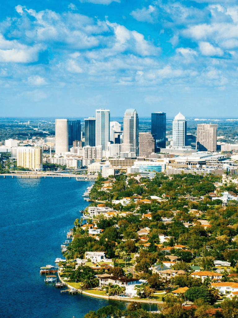 Downtown Orlando skyline with water and residential area, Florida cityscape.