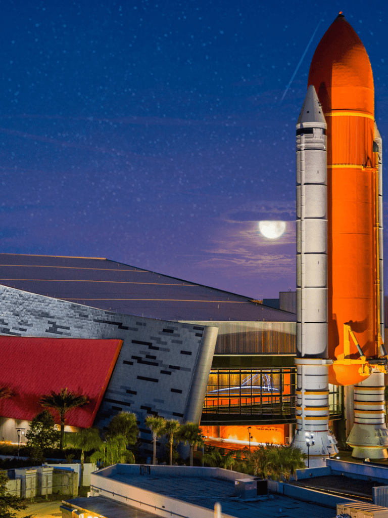 Rockets on launch pad at night, SpaceX Starship ready for space exploration, celestial sky background.