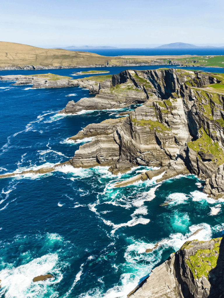 Vivid coastal cliffs and ocean waves at QuestForDirections scenic viewpoint.