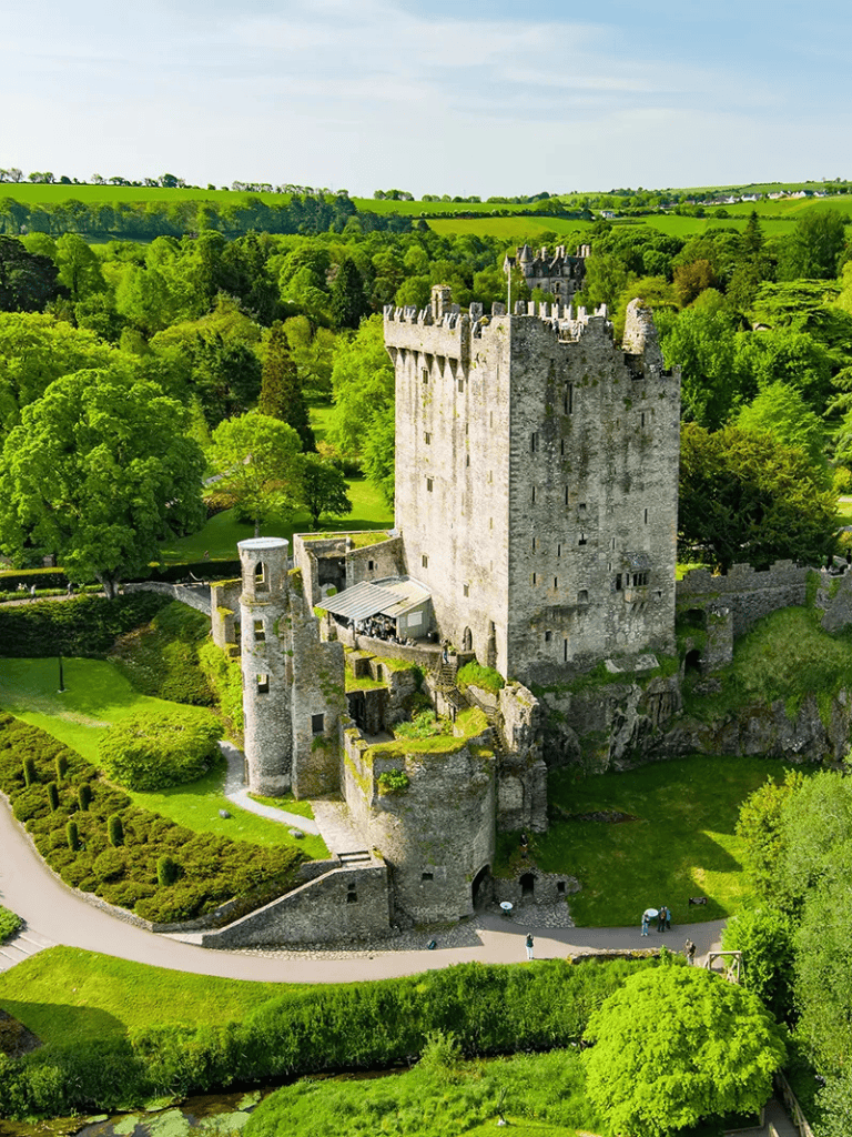 Medieval castle surrounded by lush green landscape, scenic views, and gardens, ideal for historical exploration and tourism.