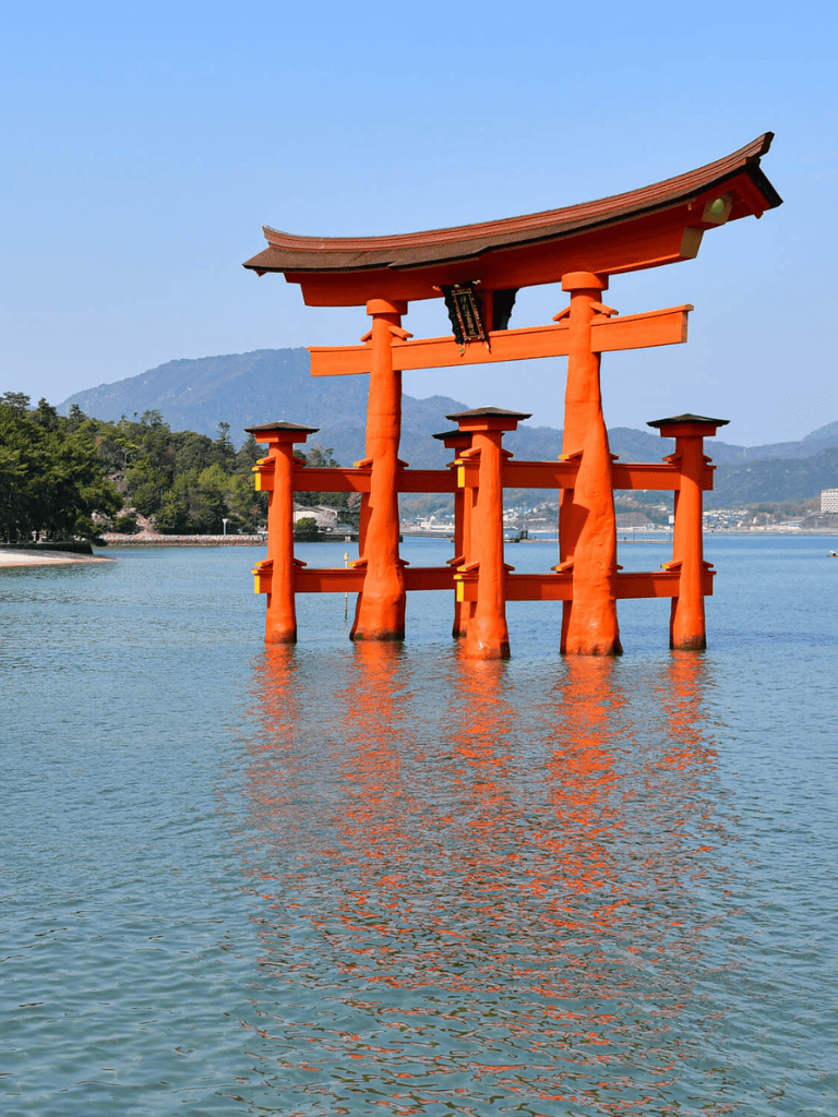 Vivid image of Japan's torii gate in water, iconic landmark in Japanese culture and spiritual site.