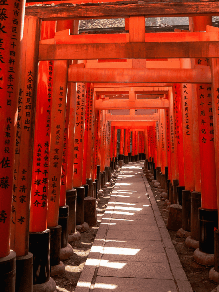 Vibrant red Torii gates at Fushimi Inari Shrine, Japan, symbolizing traditional Japanese spiritual journey.