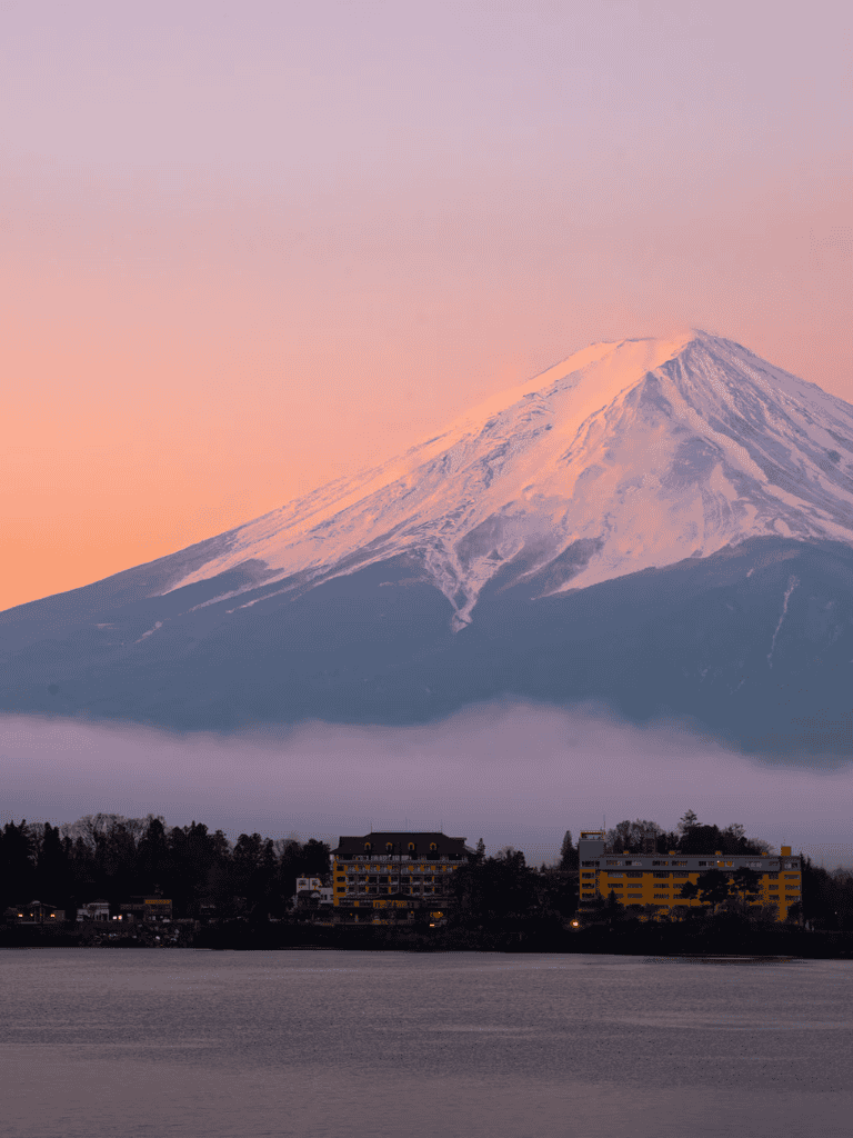 Majestic Mount Fuji with snow-capped peak at sunrise, Japan's iconic natural landmark.
