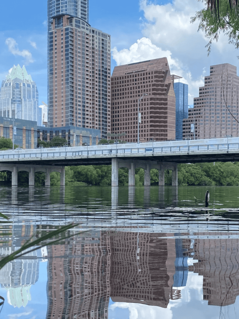 Austin city skyline with river view and paddleboarder, urban scenery, QuestForDirections.