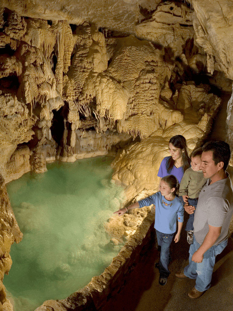 Cliff Cave Tours - Stunning underground cave with stalactites and family exploring nature.