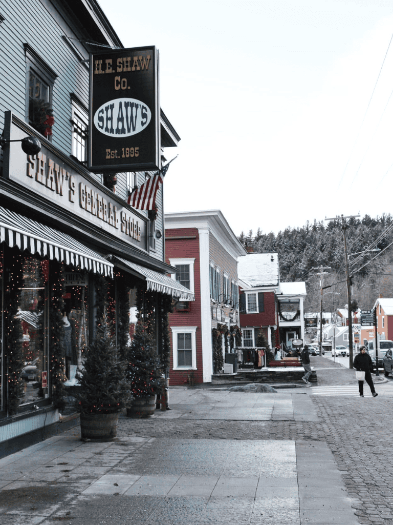 Cozy historic downtown shopping street with Christmas decorations and small businesses, perfect for local exploration and holiday shopping.