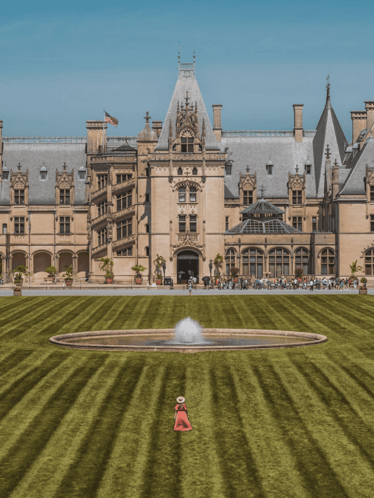 Grand historic castle with lush green lawn and fountain, perfect for travel and destination guides.