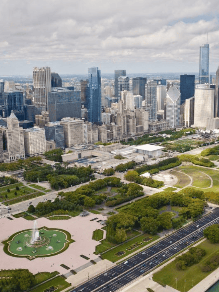 Vibrant cityscape of downtown Chicago with Millennium Park and the Cloud Gate sculpture visible.