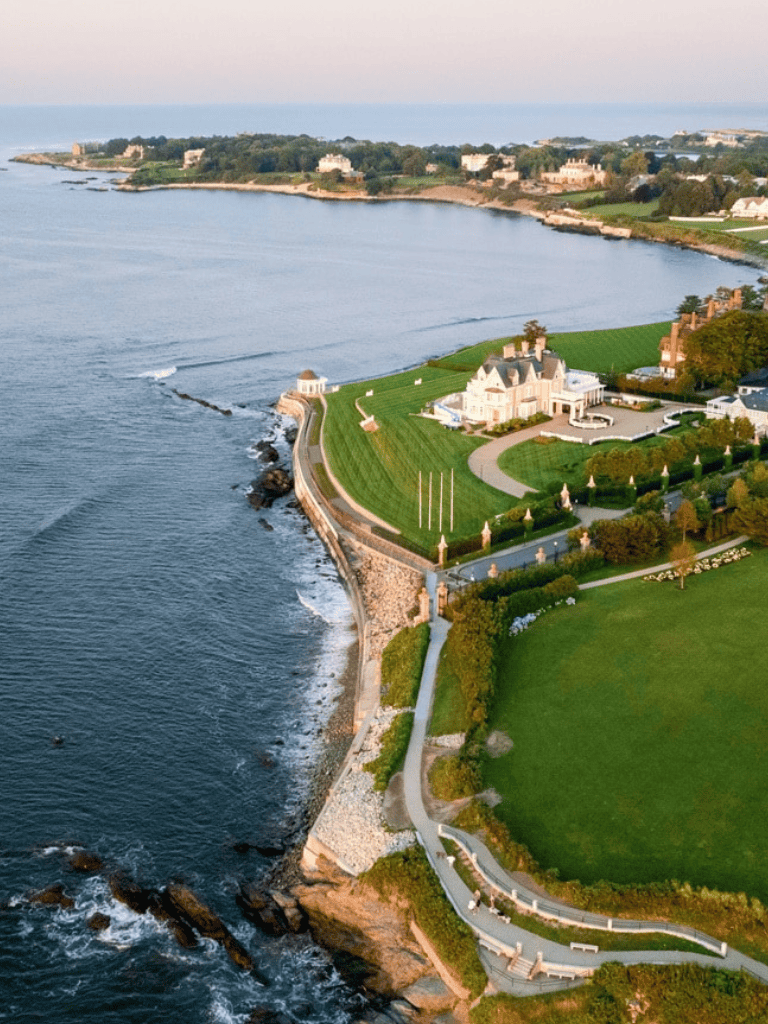Elegant coastal mansion with scenic ocean views and manicured lawns for optimal luxury living.
