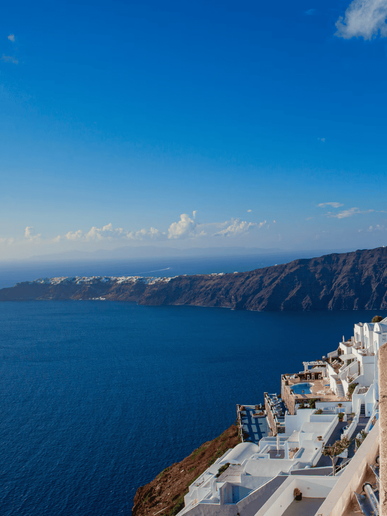 Stunning coastal view of Santorini with white buildings overlooking the deep blue Aegean Sea.