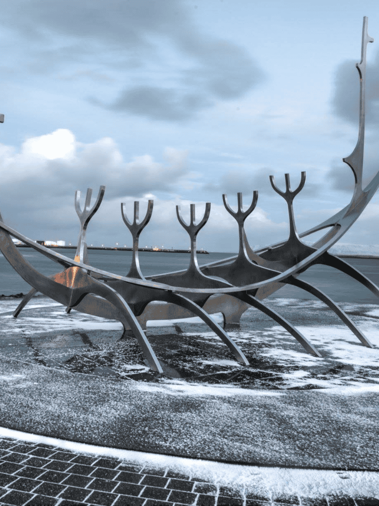 1. Large Viking Ship sculpture by the seaside in Reykjavik, Iceland, featuring modern design and scenic ocean views.