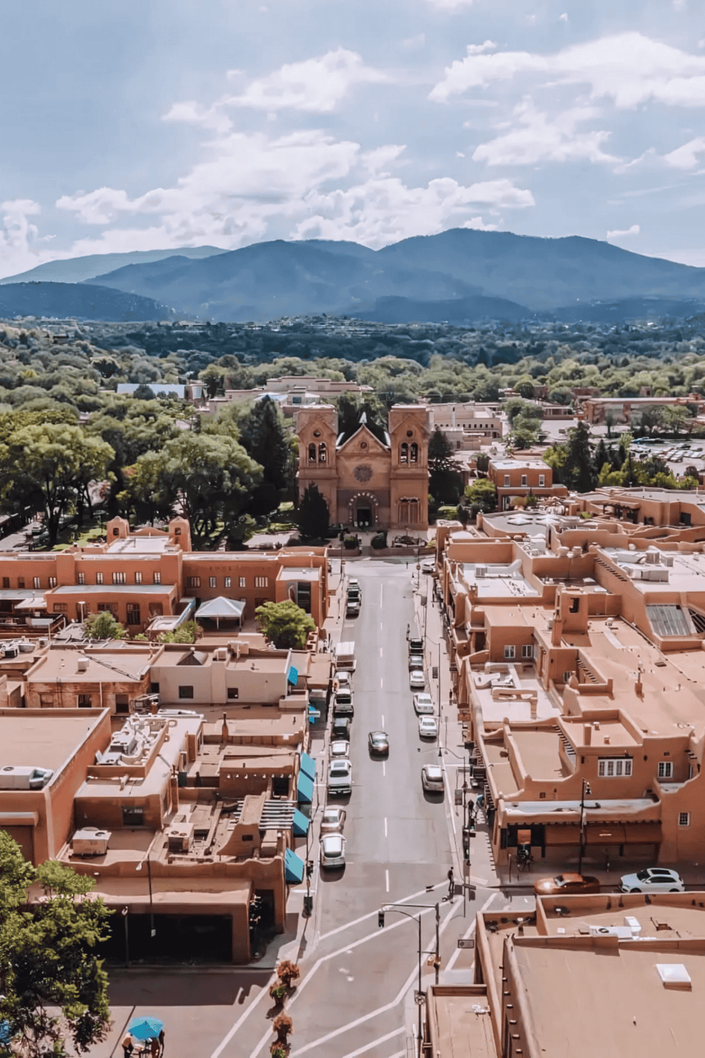 Historic downtown Albuquerque with Sandia Mountains in the background, showcasing Southwestern architecture and vibrant city life.