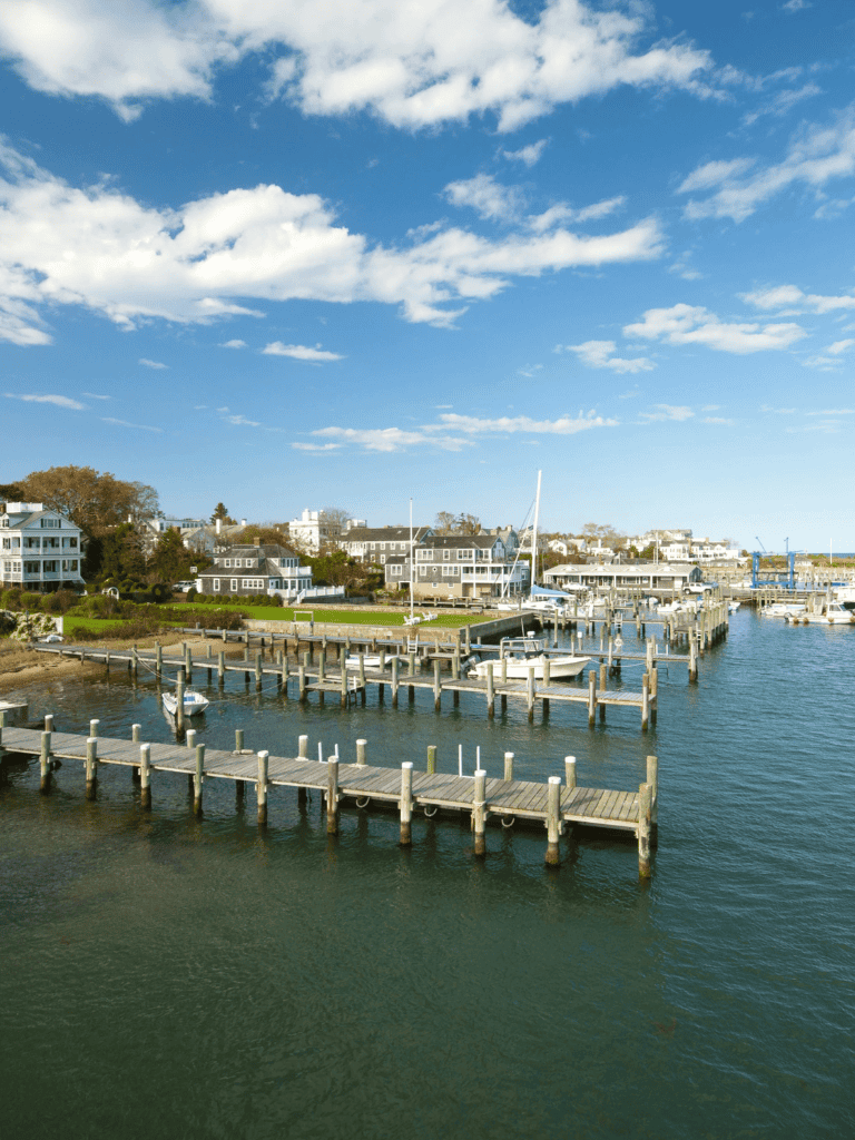 Colorful marina with boats and residential houses under blue sky, scenic waterfront view from QuestForDirections.