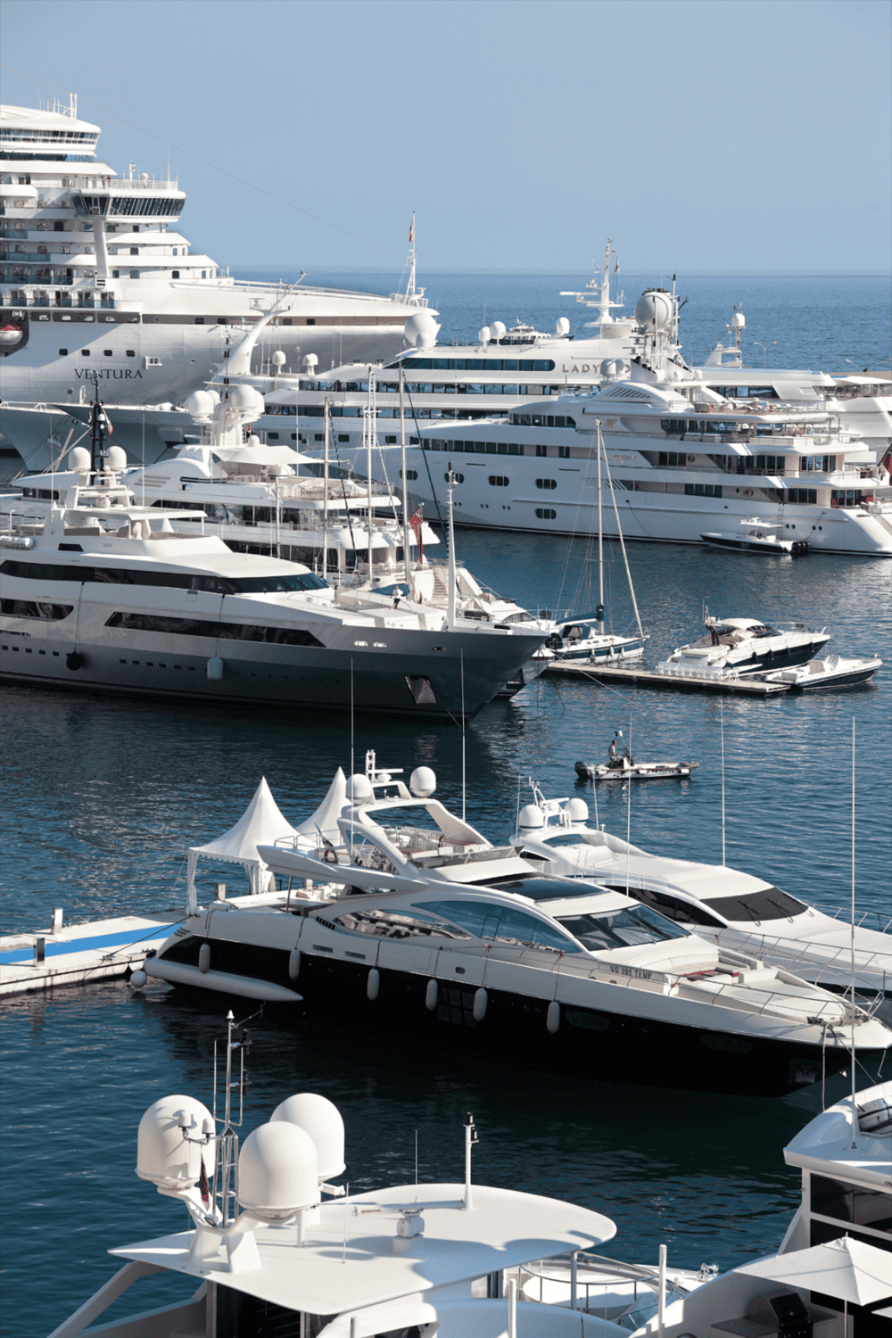 Luxury yachts docked at marina for Exclusive cruise and travel experiences.