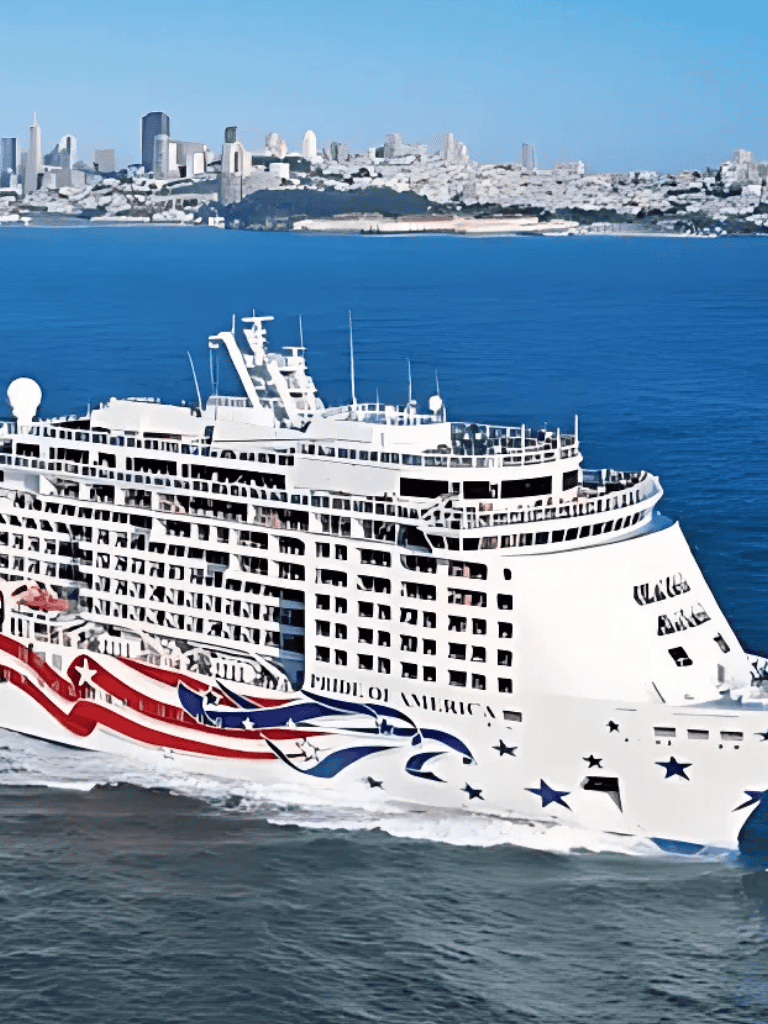 Cruise ship on San Francisco Bay with city skyline in background.
