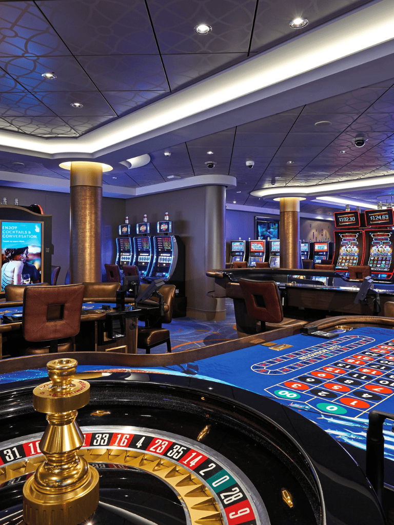 Elegant casino interior with roulette and slot machines at QuestForDirections gaming venue.