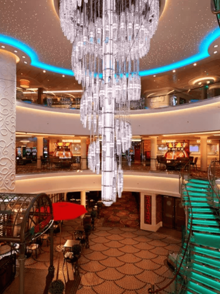 Elegant hotel lobby with a stunning crystal chandelier and modern decor, perfect for luxury travel and destination planning.