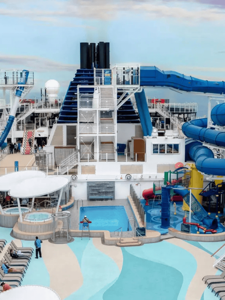 Vast cruise ship water park with water slides and pools, family-friendly cruise entertainment and amenities.