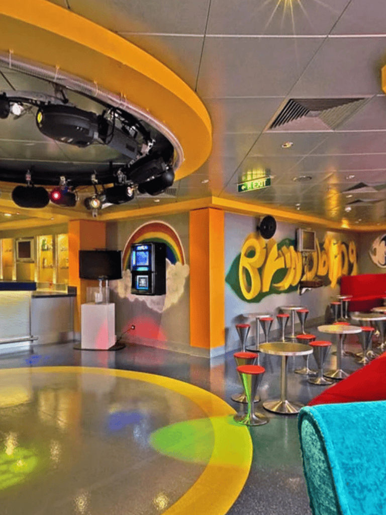 Colorful party room with lighting, sound system, and vibrant decor for karaoke and entertainment.