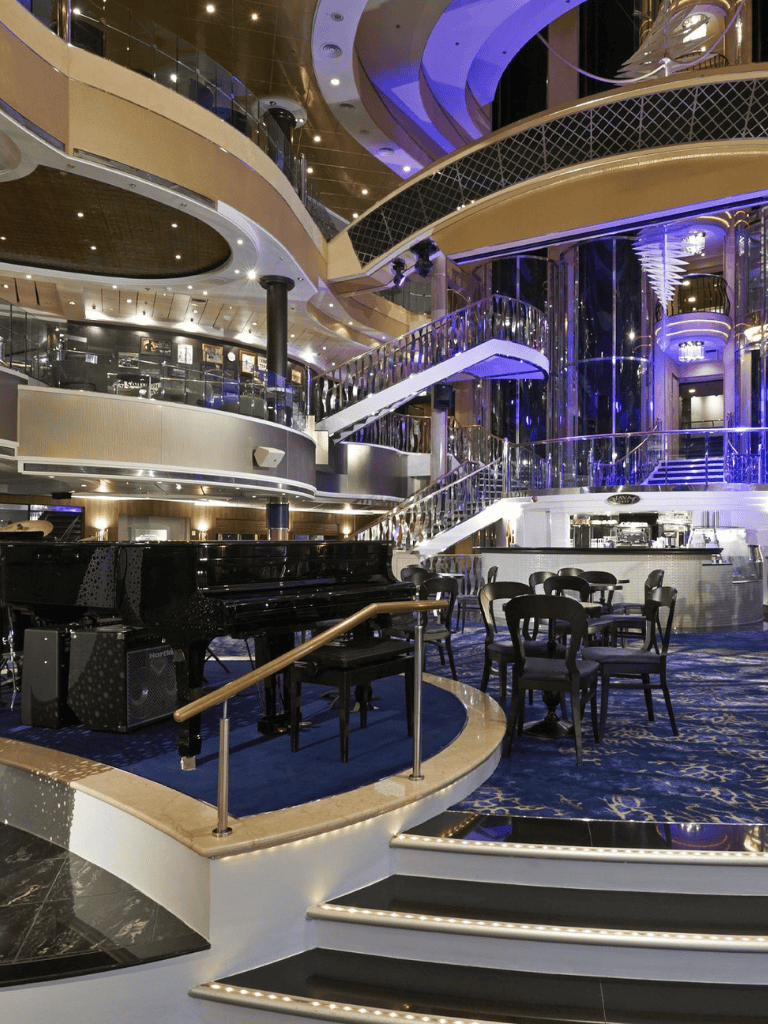 Grand cruise ship interior with modern design, glimmering lighting, and elegant furnishings for luxury voyages.