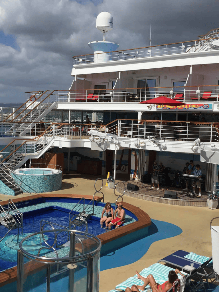 Docked cruise ship with pool and entertainment area, on a cloudy day, on the Quest for Directions vessel.