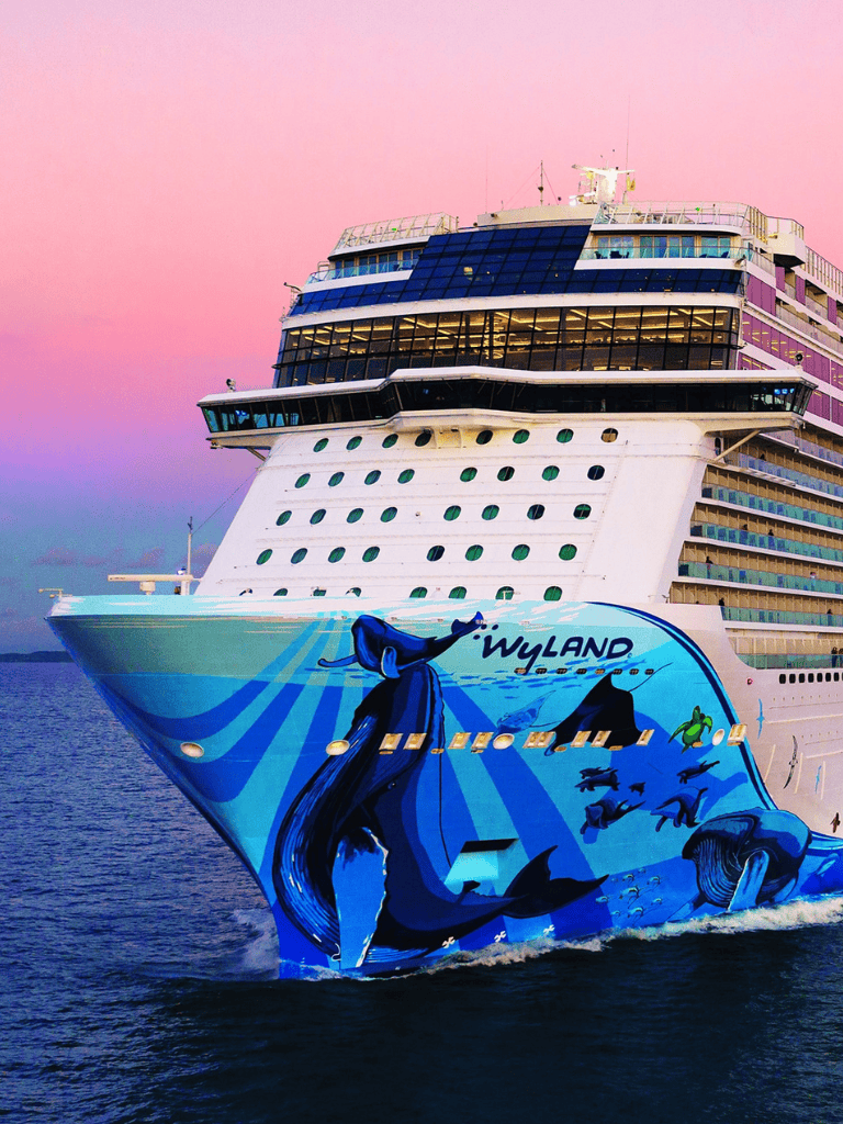 1. Large cruise ship with colorful whale artwork, ocean background, and sunset sky.