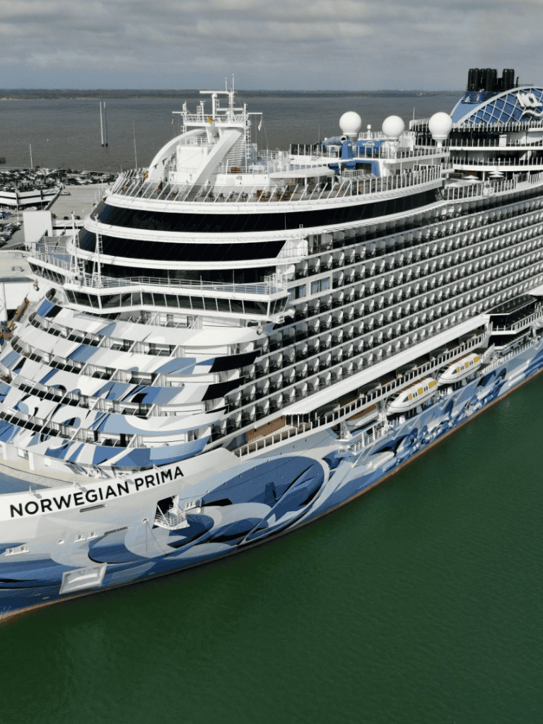 Luxurious Norwegian Prima cruise ship docked at port, ready for exciting ocean voyages.