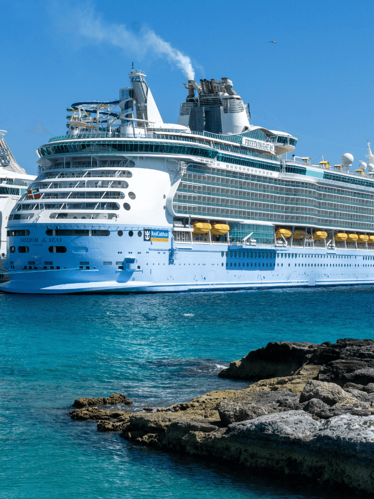 Luxury cruise ship docked at port, offering travel and vacation cruises.
