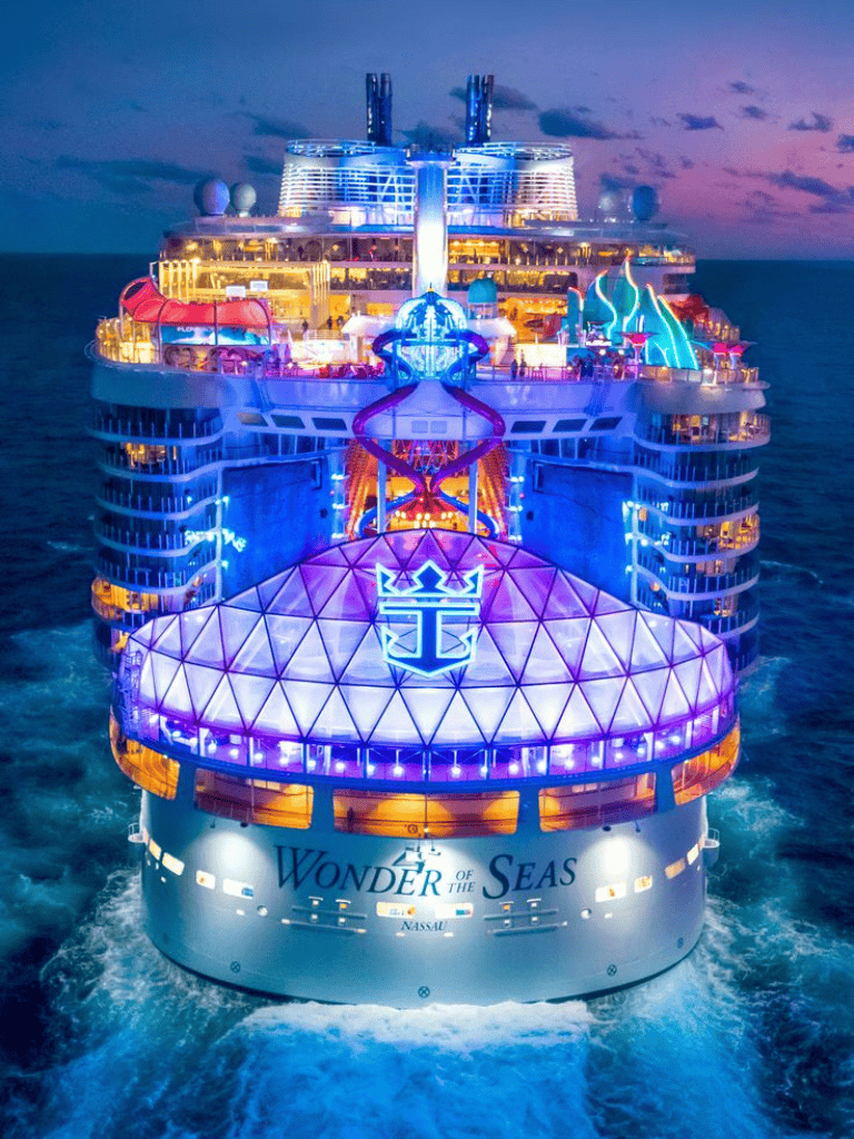 Colorful cruise ship illuminated at night, luxury vacation on Wonder of the Seas, Royal Caribbean cruise.