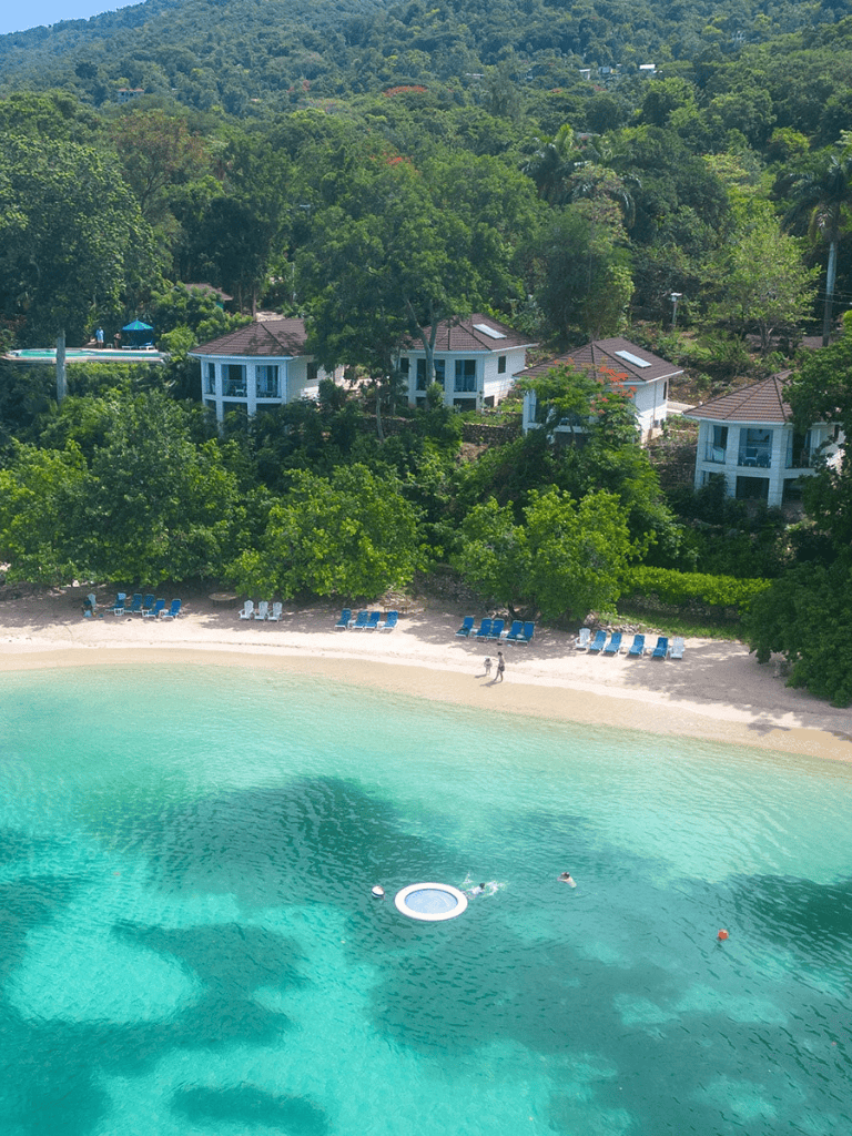 Luxurious beachside villas surrounded by lush greenery at QuestForDirections resort.