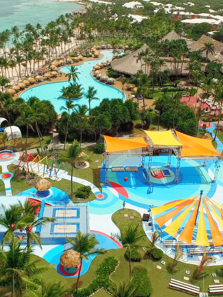 Lush tropical resort with lazy river, water slides, poolside cabanas, and beachfront access for family vacations.