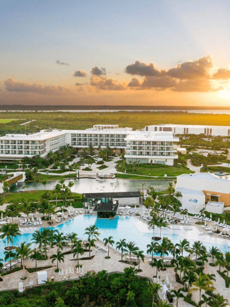 Luxury beachfront resort with pools and scenic sunset views, located near Quest For Directions.
