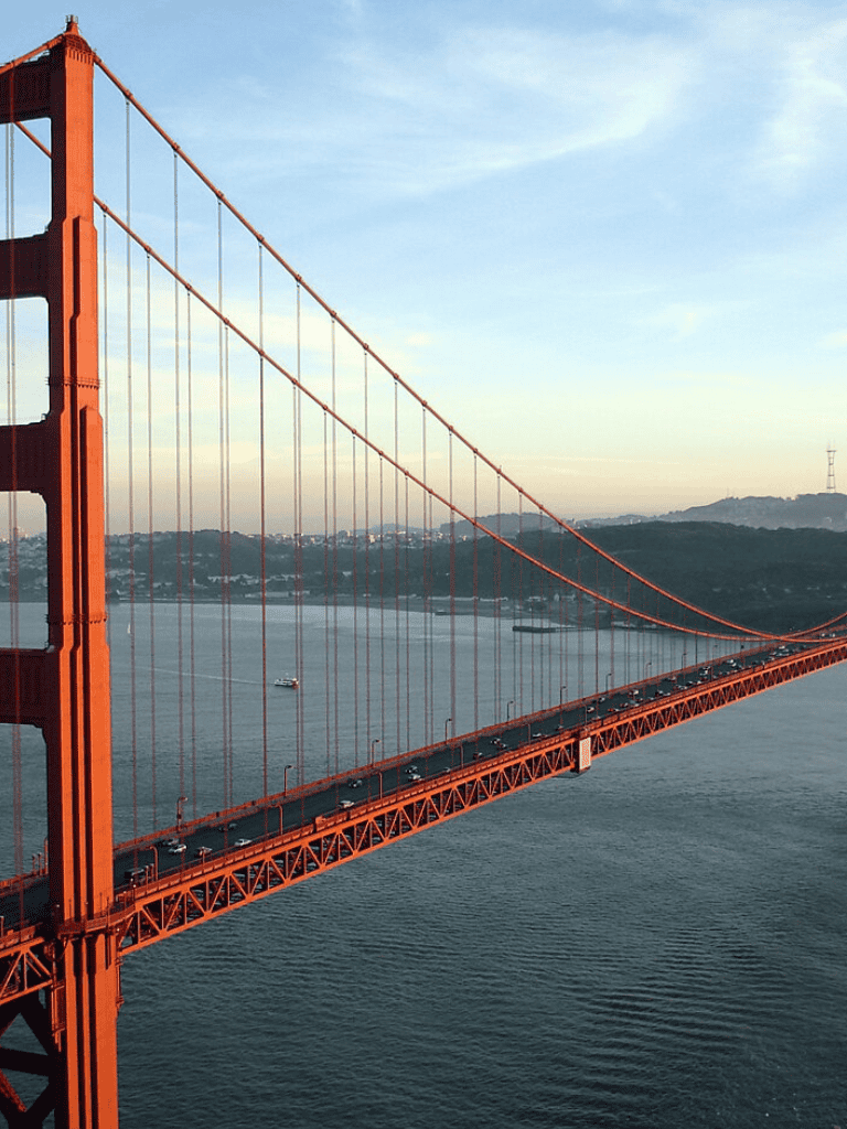 Golden Gate Bridge with cars, aerial view, San Francisco, iconic landmark, travel destination, scenic scenery.