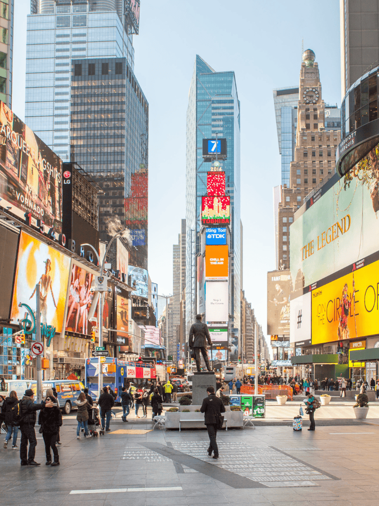 Vibrant Times Square with neon billboards and bustling crowd in New York City.