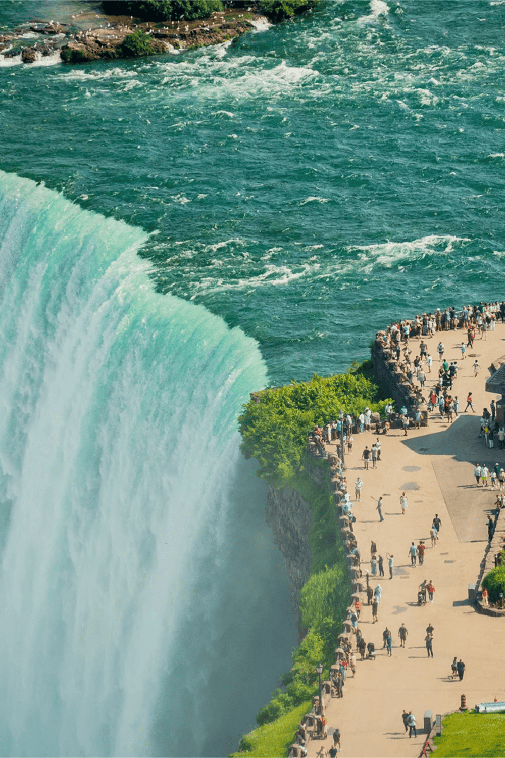 Majestic Niagara Falls with visitors enjoying the breathtaking view and scenic observation area.