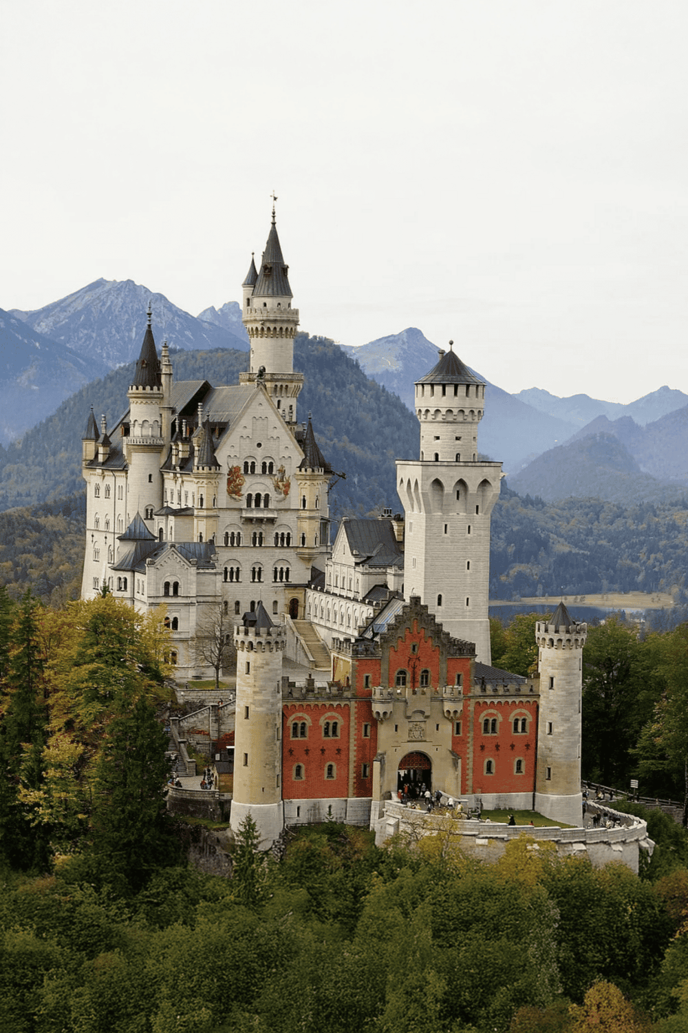 Fairy tale castle with mountains in background, scenic European destination, popular tourist attraction.
